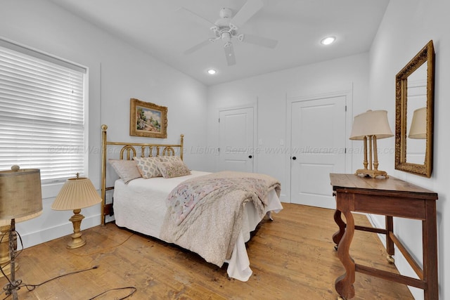 bedroom featuring light wood-type flooring and ceiling fan