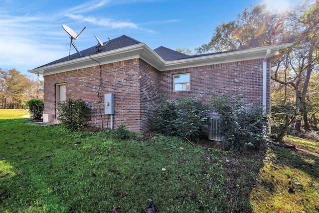 view of side of property with a yard