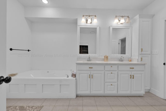 bathroom featuring tile patterned floors, vanity, and a tub to relax in