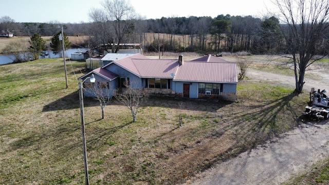 birds eye view of property featuring a water view and a wooded view