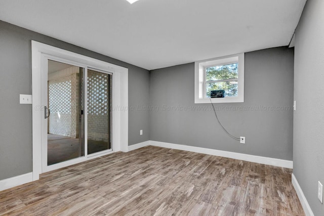 unfurnished room featuring hardwood / wood-style flooring