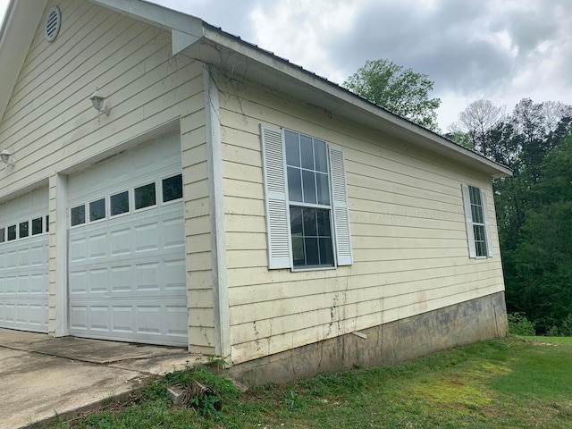 view of property exterior with an outbuilding and a garage