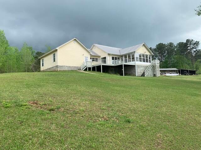 rear view of house with a lawn