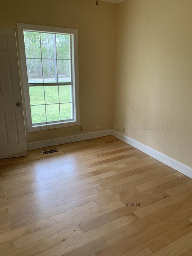 empty room with light hardwood / wood-style flooring