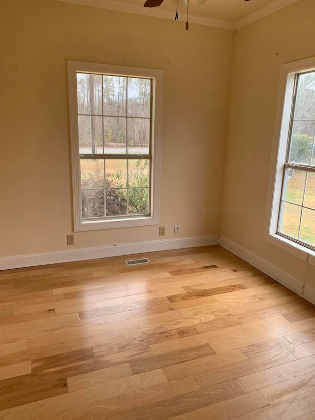 spare room with light hardwood / wood-style flooring, ceiling fan, and ornamental molding