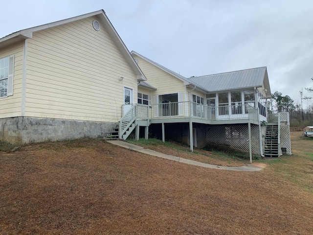 back of house featuring a deck and a sunroom