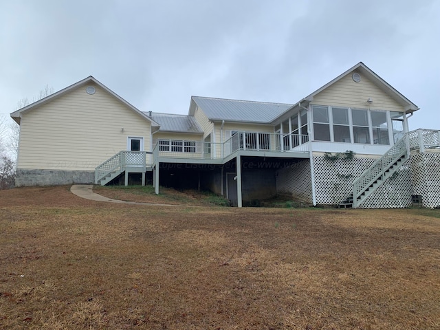 back of house with a sunroom and a deck