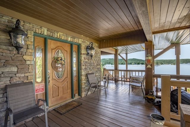 property entrance with a water view and covered porch