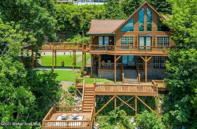 back of house featuring a yard, a wooden deck, and french doors