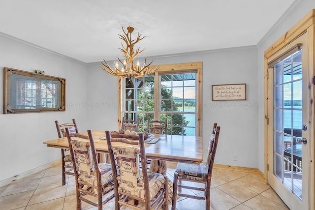 tiled dining area featuring a chandelier and ornamental molding