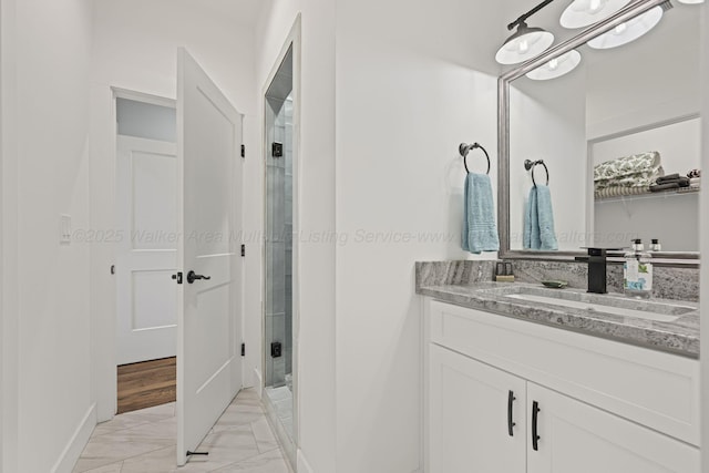 bathroom with vanity and a shower with door