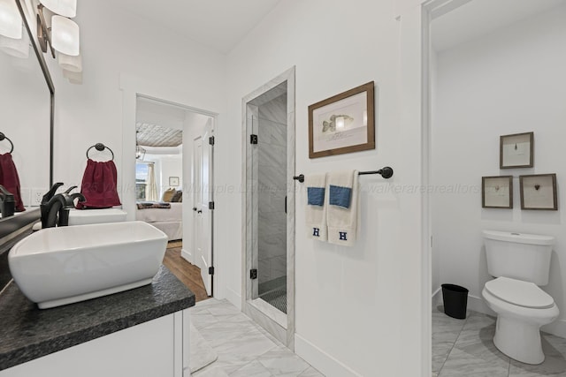 bathroom with walk in shower, vanity, and toilet