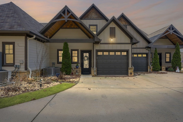 craftsman-style house featuring a garage and central AC unit