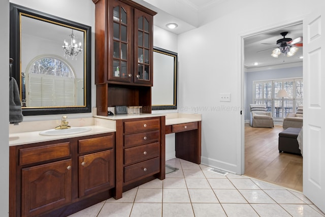 bathroom featuring ensuite bathroom, tile patterned floors, vanity, and crown molding