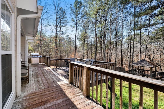 wooden terrace featuring a gazebo