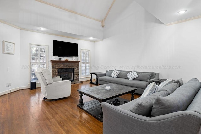 living area featuring a fireplace with raised hearth, baseboards, dark wood finished floors, and crown molding