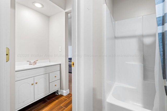 full bathroom featuring vanity and wood finish floors