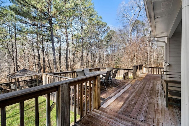 wooden deck featuring outdoor dining area