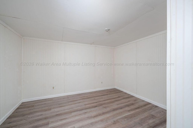 spare room with wood-type flooring