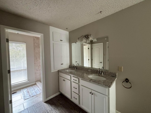 bathroom with vanity, a textured ceiling, and hardwood / wood-style flooring