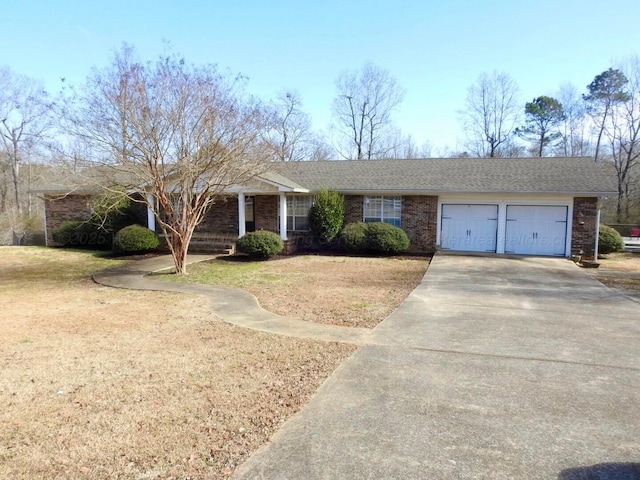 ranch-style home with a garage and a front lawn