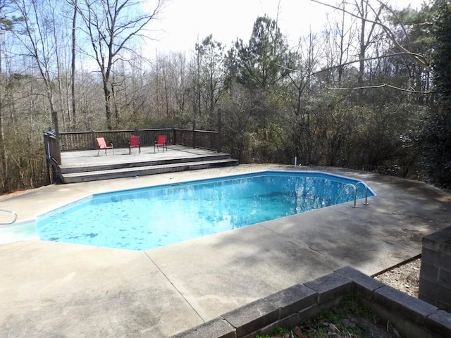 view of swimming pool with a wooden deck