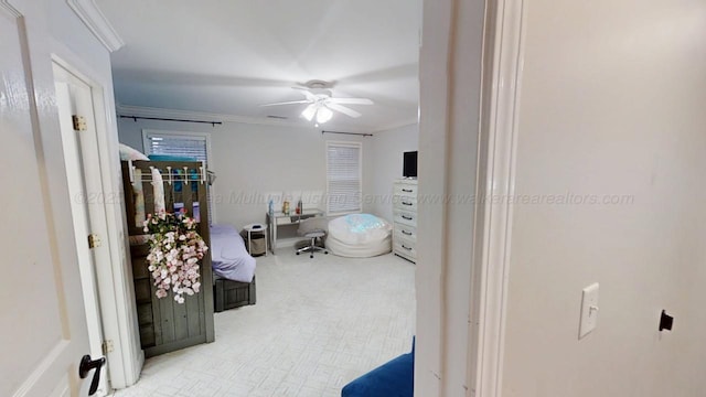 bedroom with ceiling fan and crown molding