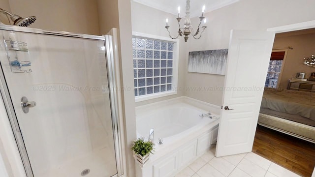 bathroom featuring a stall shower, tile patterned flooring, a bath, and ensuite bathroom