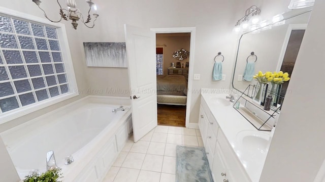 bathroom with a garden tub, a sink, tile patterned floors, double vanity, and ensuite bath