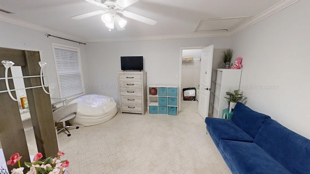 interior space with visible vents, ceiling fan, ornamental molding, and attic access