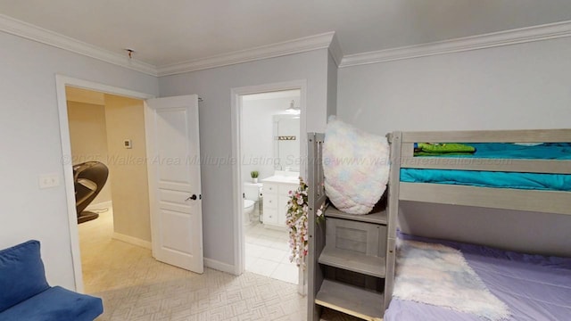 bedroom with ensuite bath, ornamental molding, baseboards, and light colored carpet