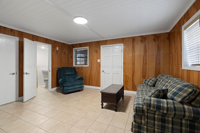 tiled living room featuring crown molding and wood walls