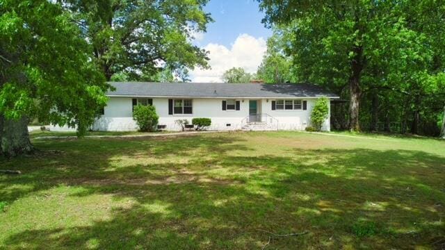 rear view of property with a lawn