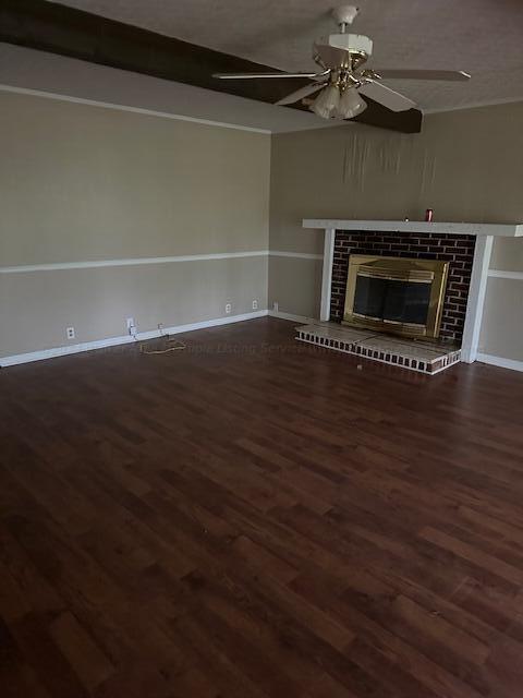 unfurnished living room featuring dark hardwood / wood-style floors and ceiling fan