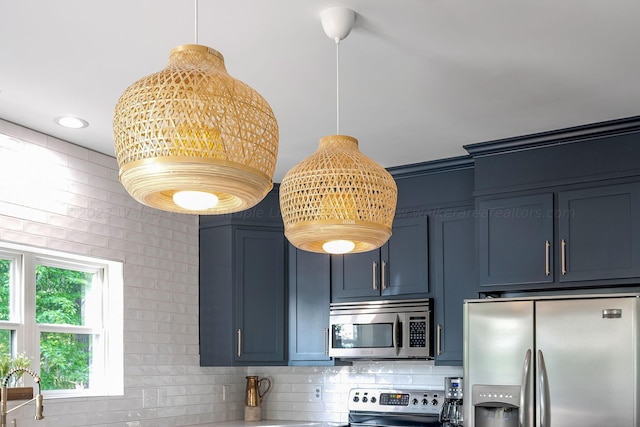 kitchen featuring stainless steel appliances, blue cabinets, and backsplash