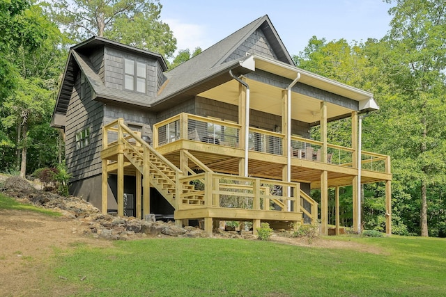 back of property featuring a deck and a lawn