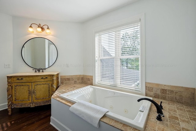 bathroom with vanity, a bathtub, and hardwood / wood-style floors