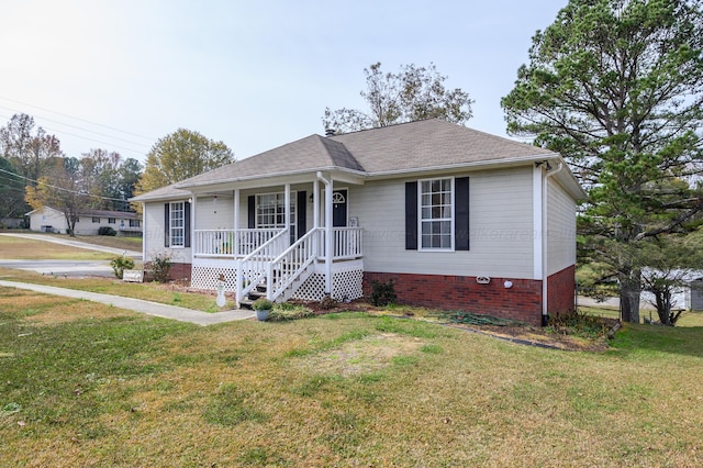 ranch-style house featuring a front yard and covered porch