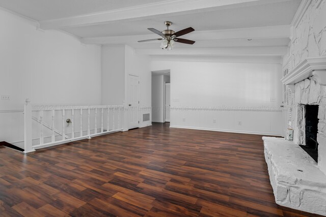 unfurnished living room with dark hardwood / wood-style flooring, a fireplace, ornamental molding, ceiling fan, and beamed ceiling