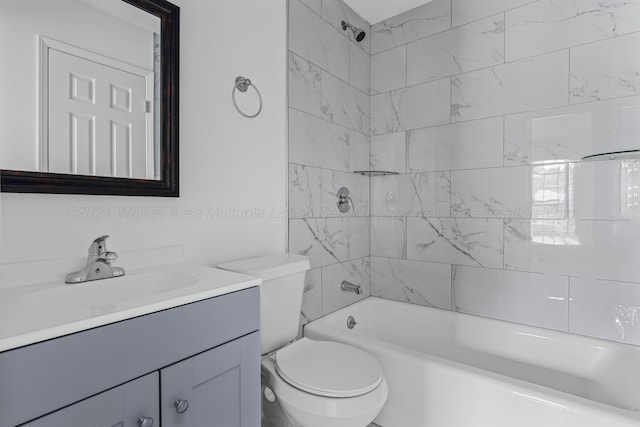 full bathroom featuring toilet, vanity, and tiled shower / bath