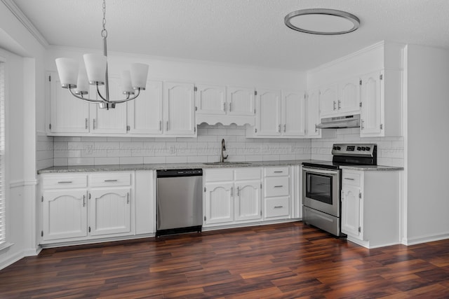 kitchen with appliances with stainless steel finishes, sink, pendant lighting, white cabinets, and dark hardwood / wood-style floors