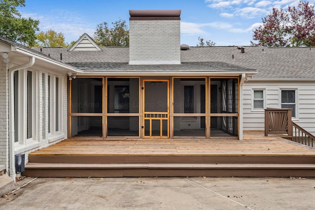 wooden deck with a sunroom