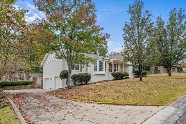 view of front of home with a garage and a front lawn