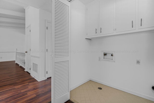 washroom with cabinets, hookup for a washing machine, dark hardwood / wood-style floors, and hookup for an electric dryer