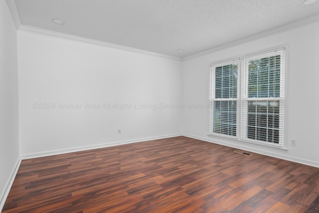 unfurnished room featuring a textured ceiling, dark hardwood / wood-style flooring, and ornamental molding