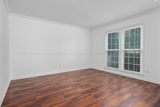 unfurnished room featuring a textured ceiling, dark hardwood / wood-style flooring, and ornamental molding