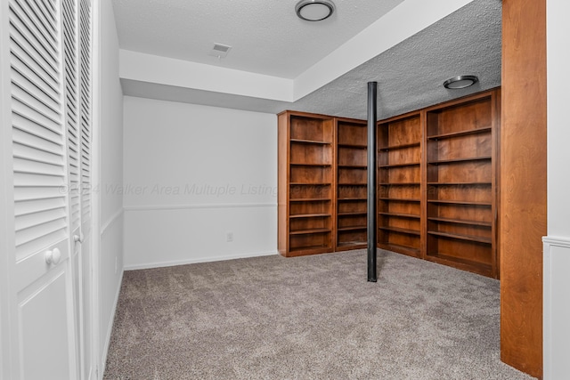 unfurnished bedroom with carpet floors and a textured ceiling