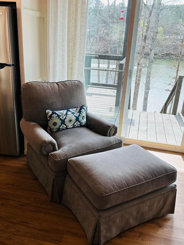 sitting room with hardwood / wood-style floors and a healthy amount of sunlight