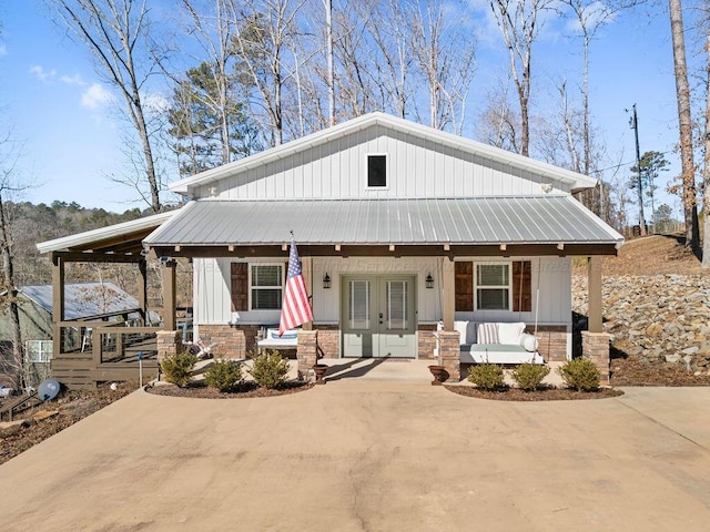 view of front of house featuring covered porch and french doors