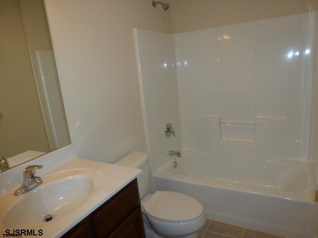 full bathroom with vanity, tile floors, shower / bathing tub combination, and toilet